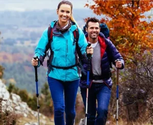 Two hikers with trekking poles enjoying a fall hike in Minnesota near the Twin Cities