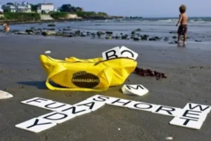 Jumbo Bananagrams game with large tiles and yellow bag on the beach, available for rent at North Sport Rentals