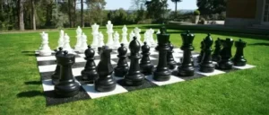 A giant chess set arranged on a lawn, perfect for outdoor events and available at North Sport Rentals