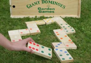 Giant dominoes game pieces set up on grass, available for rent at North Sport Rentals