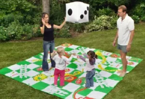 Outdoor giant Kerplunk game with two players removing sticks, available at North Sport Rentals