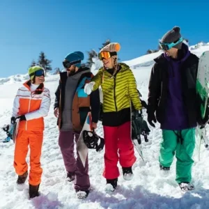 Four friends walking together in the snow with snowboarding gear in Minneapolis from North Sport Rentals