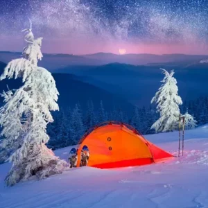 Orange winter camping tent set up in a snowy mountain landscape under a starry sky in Minneapolis