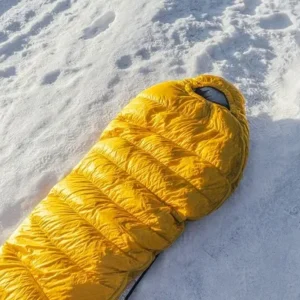 Yellow winter sleeping bag on the snow in Minnesota