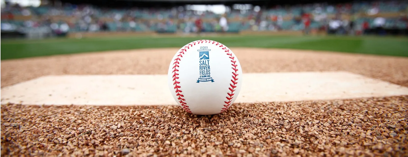 Close-up of a baseball on a pitcher's mound, showcasing North Sport Rentals' corporate baseball rentals for team-building events and company picnics.