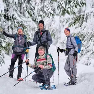 Group of friends snowshoeing through snowy trails in Maple Grove with rental gear from North Sport Rentals