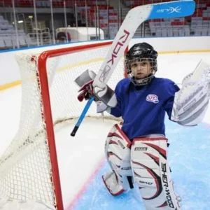 Young ice hockey goalie in full gear during practice in Minnesota