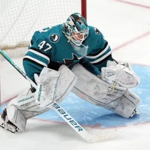 Ice hockey goalie in action wearing full goalie gear in Minnesota