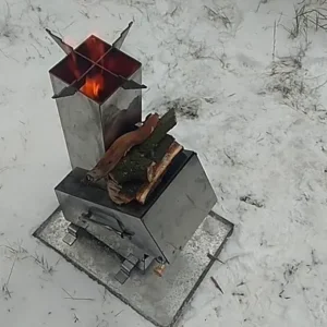 Metal fire pit with flames and logs set against a snowy landscape, perfect for winter camping in Minnesota