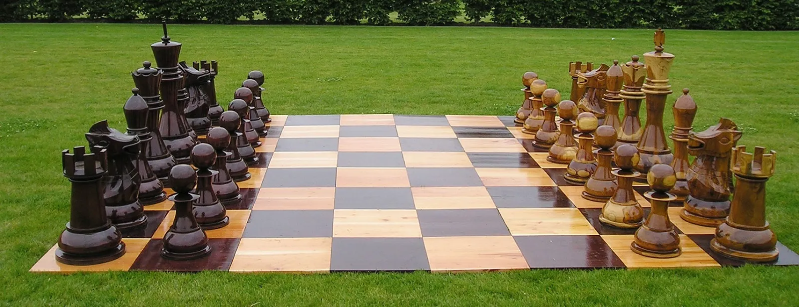 Large wooden giant chess set on an outdoor lawn, available for rent at North Sport Rentals. Check our Party game rentals today.