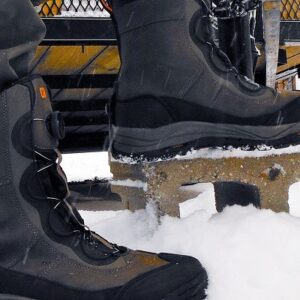 Close-up of snowmobile boots designed for warmth and durability in snowy conditions.