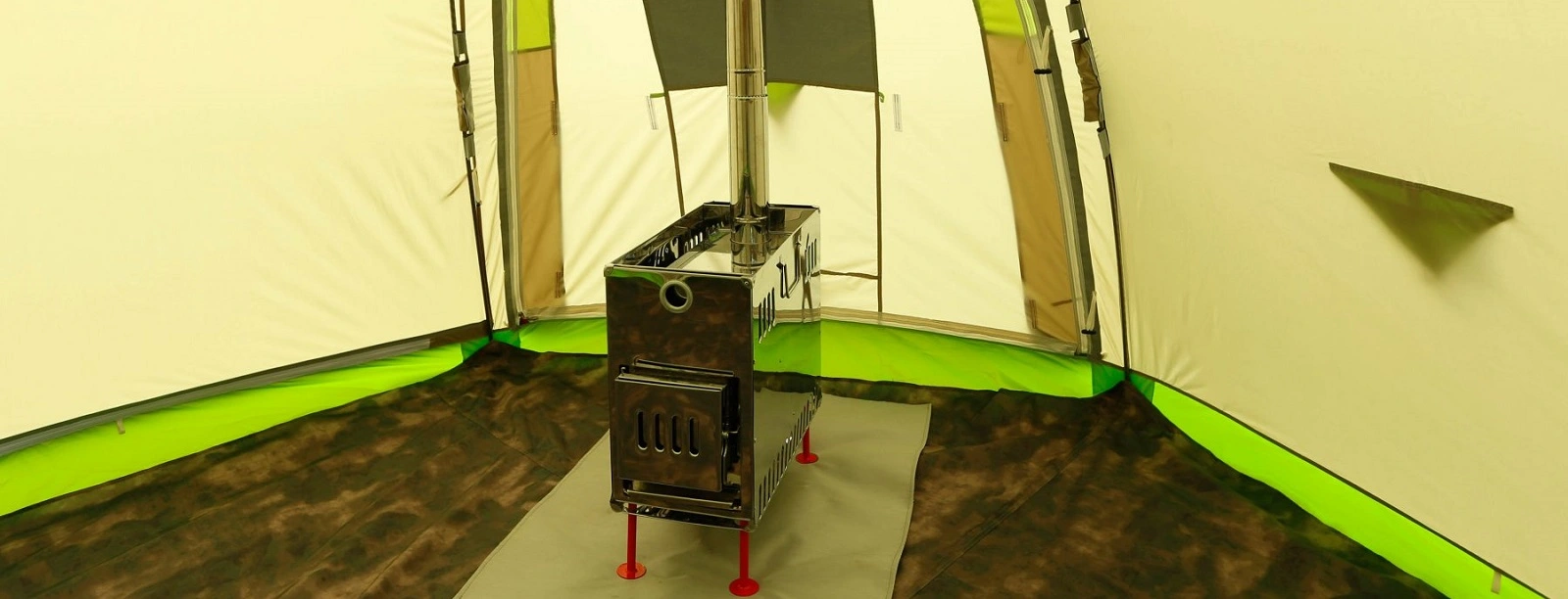 Interior view of a portable sauna rentals setup featuring a compact stove inside a spacious tent, perfect for outdoor relaxation.