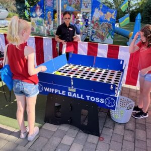 Tabletop and carnival games arranged at a corporate team-building event outdoors