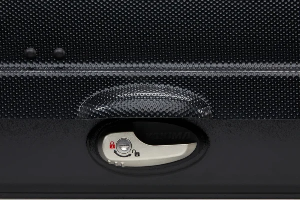 b0fc1e6a-2f22-43ad-84c5-15e8592ff273_1296x - North Sport Rentals Close-up of a silver suitcase lock with a red unlocked icon and a circular keyhole, set into a black textured suitcase surface near the zipper.